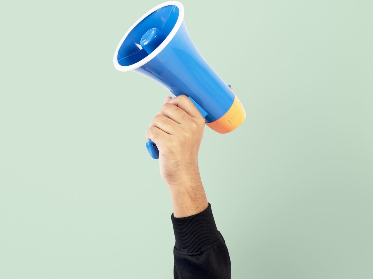 advertise with us, a man hanging a microphone